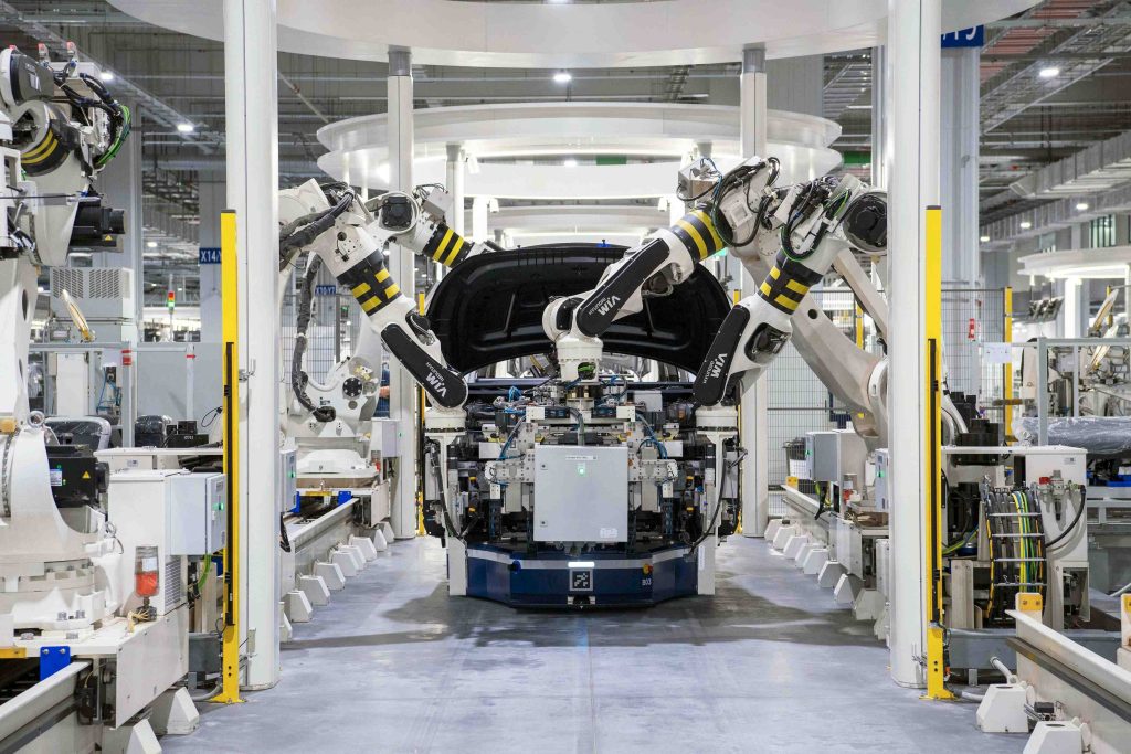 An image of robotic arms assembling a car