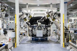 An image of robotic arms assembling a car