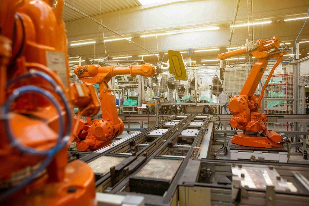 An image of robot arms in a factory